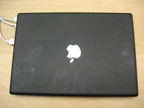 Black MacBook lid covered in fingerprints