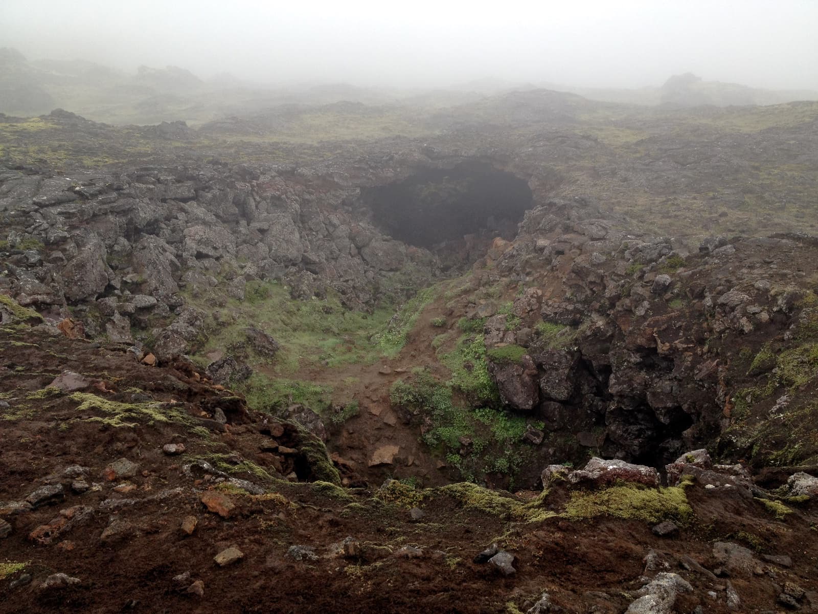 Very rugged terrain with person-sized holes where lava once flowed