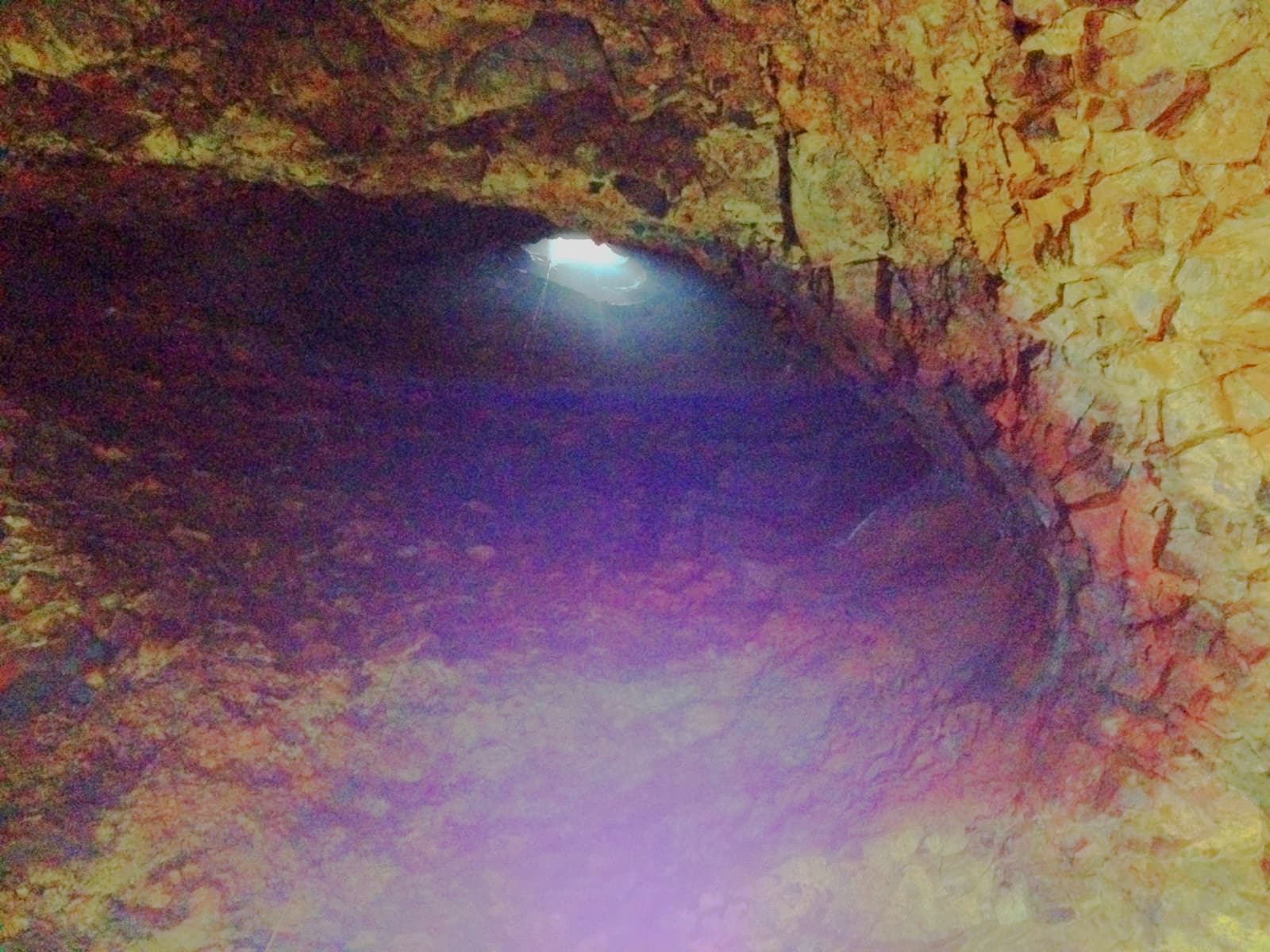 Looking 700 feet/215 meters upward from the bottom of a lava tube towards a small aperture where the sunlight enters