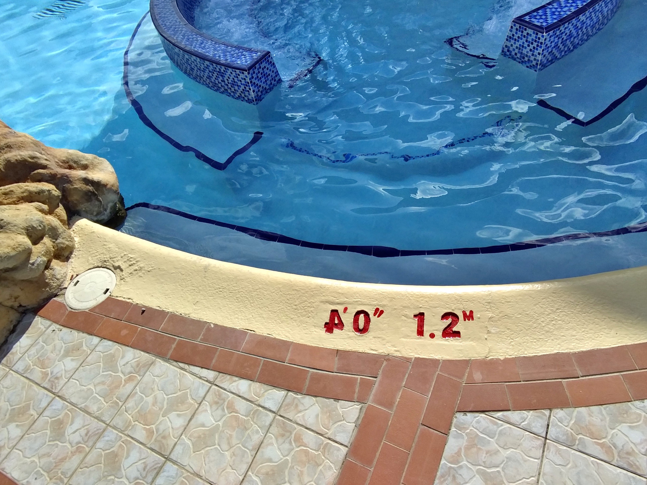 A pool marker stating 4-foot 0-inches, but the 4 is backwards