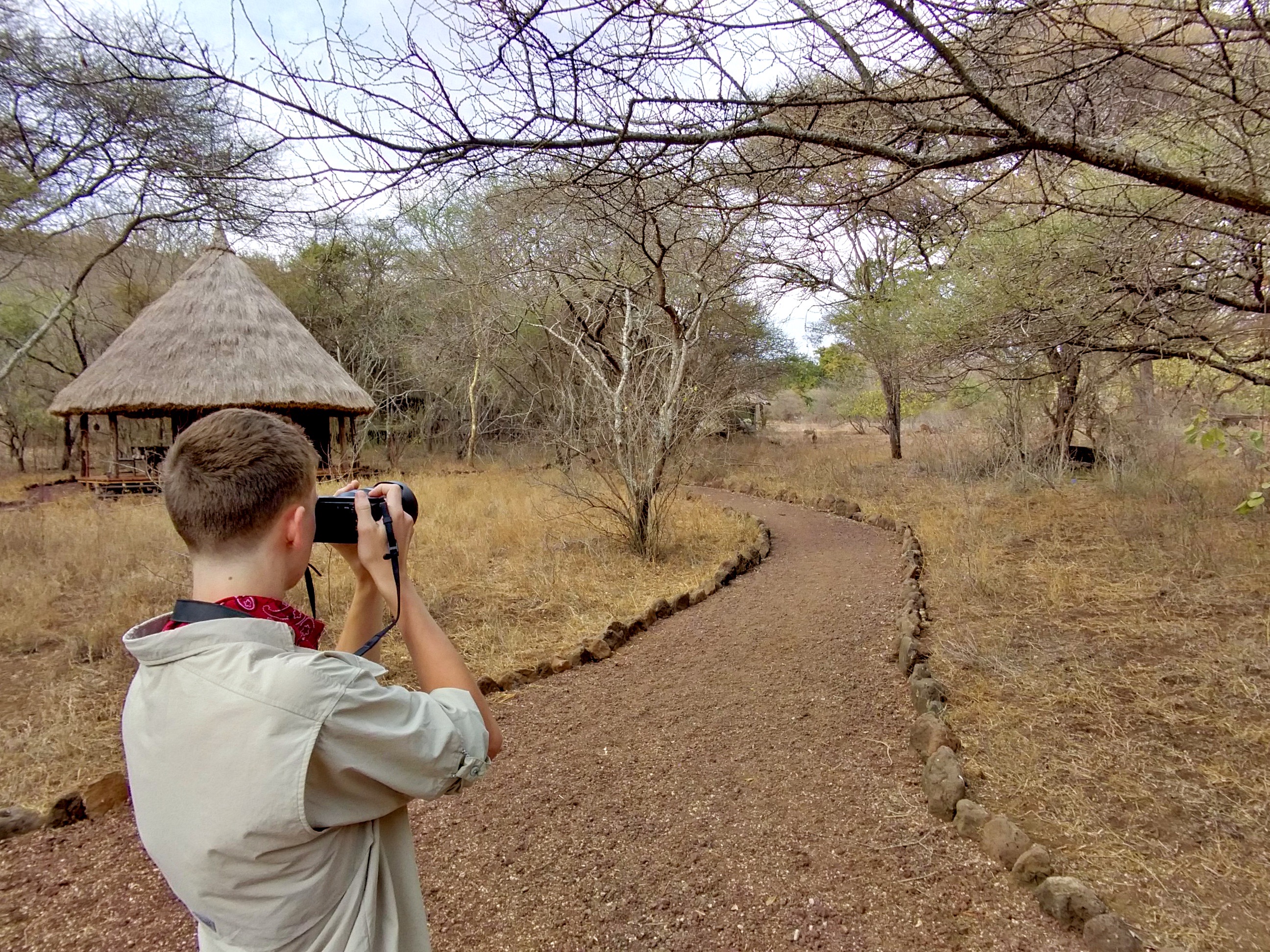 Young man taking a photo in Tanzania
